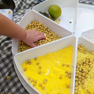 Little Ones: yellow sensory chickpeas and sand in an inspire my play tray